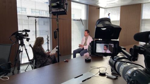 camera crew filming lit interview in office in Barcelona